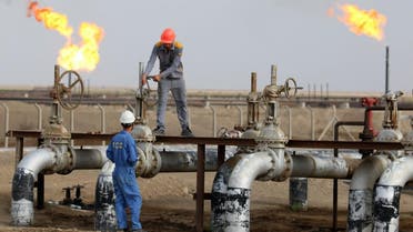Iraqi labourers work at an oil refinery in the southern town Nasiriyah. afp