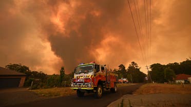 Firetrucks are seen stationed on a road as a bushfire burns in Bargo, southwest of Sydney on December 21, 2019. A scorching heatwave intensified bushfires ravaging parts of Australia on December 21, and out-of-control blazes surrounding Sydney worsened under "catastrophic" conditions.