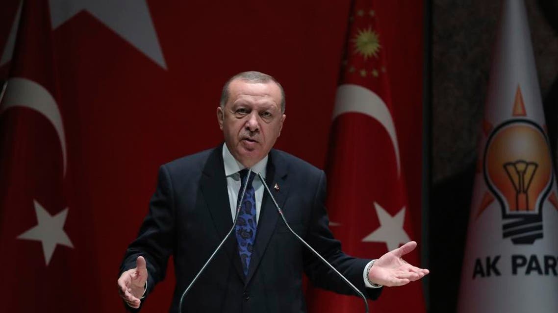Turkey's President Recep Tayyip Erdogan addresses the members of his ruling party, in Ankara, Turkey, Thursday, Dec. 26, 2019. Erdogan says Thursday his government will submit a bill to parliament that would allow Turkey to send troops to Libya, in support of the U.N.-backed government there. Erdogan said the Libyan government, which controls the capital, Tripoli, has "invited" Turkey to send troops. (Turkish Presidency via AP, Pool)