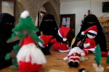 Palestinian women wearing face veil, niqab, make Santa-themed Christmas toys in the northern Gaza Strip December 29, 2019. Picture taken December 29, 2019. REUTERS