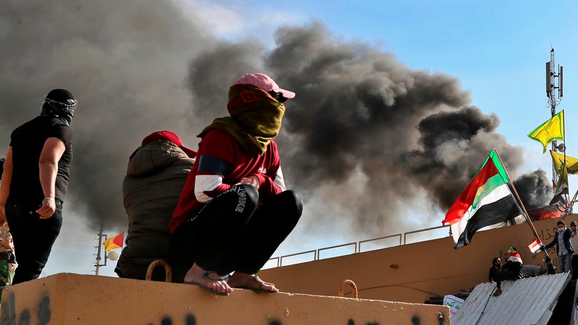 Pro-Iranian militiamen and their supporters set a fire during a sit-in in front of the U.S. embassy in Baghdad, Iraq, Wednesday, Jan. 1, 2020. (AP)