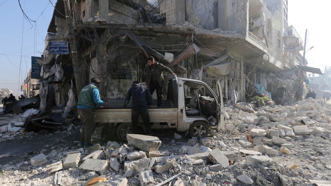 People gather in the the market in the city of Saraqeb in the Idlib countryside after an air strike by Syrian aircraft on Saturday, Dec. 21, 2019. (AP)