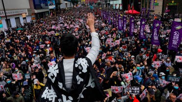 A protestor shows five demands gesture as Hong Kong people participate in their annual pro-democracy march in Hong Kong, Wednesday, Jan. 1, 2020. (AP)