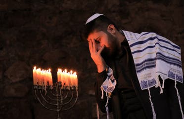A member of Iraq's Kurdish Jewish community takes part in a ceremony on the last night of the Jewish holiday of Hanukkah. (AFP)