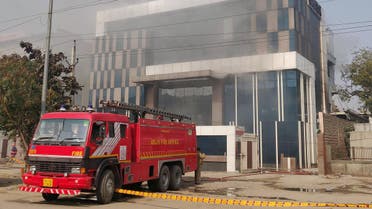 A Delhi Fire Service truck is parked next to the site of a fire and building collapse at a factory for Okaya batteries in New Delhi on January 2, 2020. (AFP)