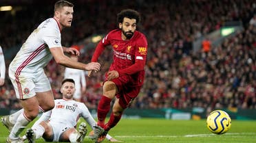 Sheffield United’s Jack O'Connell (left), and Liverpool’s Mohamed Salah run for the ball during the English Premier League soccer match between Liverpool and Sheffield United at Anfield Stadium, Liverpool, England, on January 2, 2020. (AP)