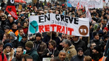 People hold a banner reading "On strike untill withdrawal" during a demonstration called by French national trade union General Confederation of Labour (CGT) against the pension reform on January 4, 2020, in Paris. (AFP)