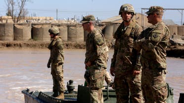 US army forces supervise during a training session at the Taji camp, north of Baghdad, with Iraqi soldiers, aimed at preparing them to install floating bridges, ahead of installing replacement ones in Mosul, on March 6, 2017. Members of the Iraqi army's Bridging Battalion who have completed the training will be deployed in the area of Mosul, where government-led forces are fighting to retake the Islamic State jihadist group's last urban stronghold in the country. Iraqi forces have deployed floating bridges on a number of occasions as they waged war against the jihadists in the Land of the Two Rivers.