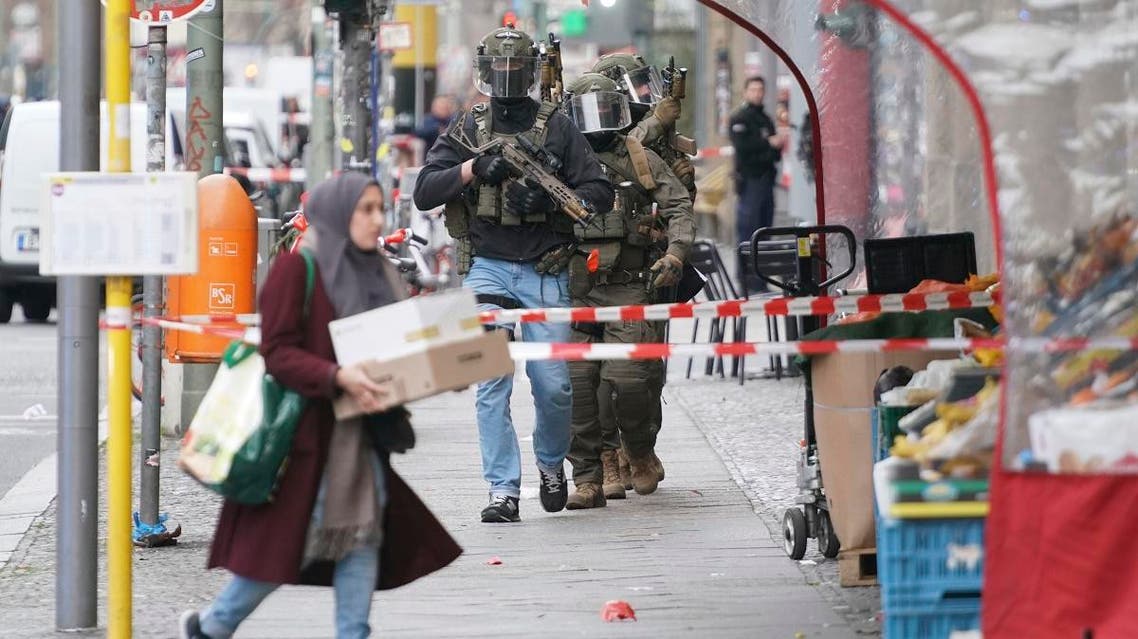 Police officers of the SWAT Team SEK walk over the Kochstrasse during a police operation near the former Checkpoint Charlie in Berlin, Germany, Monday, Dec. 30, 2019. (AP)