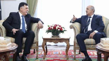 Algeria's President Abdelaziz Tebboune (R) meets with Libya's UN-recognised Prime Minister Fayez al-Sarraj upon his arrival in Algiers on January 6, 2020 for talks on the Libyan crisis. (AFP)