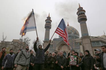 Iranians burn an Israeli and a US flag during an anti-US protest over the killing of Qassem Soleimani. (AFP)