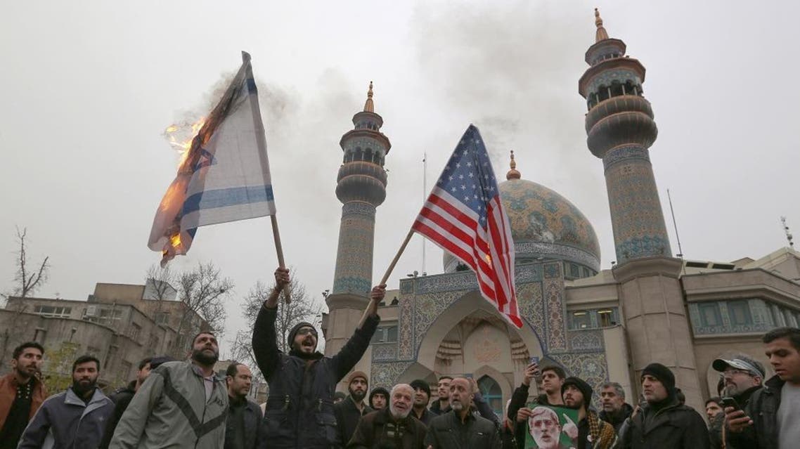 Iranians burn an Israeli and a US flag during an anti-US protest over the killing of Qassem Soleimani. (AFP)