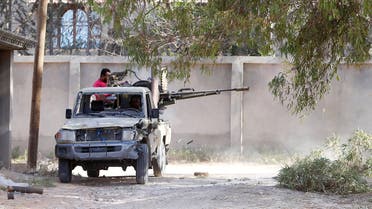 Members of the Libyan internationally recognised government forces fire during a fight with Eastern forces in Ain Zara, Tripoli