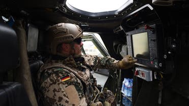 A German soldier controls a machine gun as he displays a paroling military vehicle. (File photo: AFP)