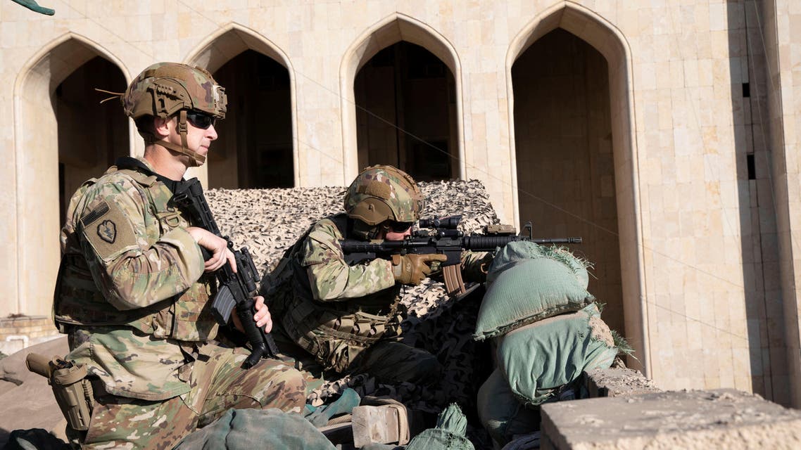 US Army soldiers from 1st Brigade, 25th Infantry Division, Task Force-Iraq, man a defensive position at Forward Operating Base Union III in Baghdad, Iraq, December 31, 2019 - Reuters.jpg