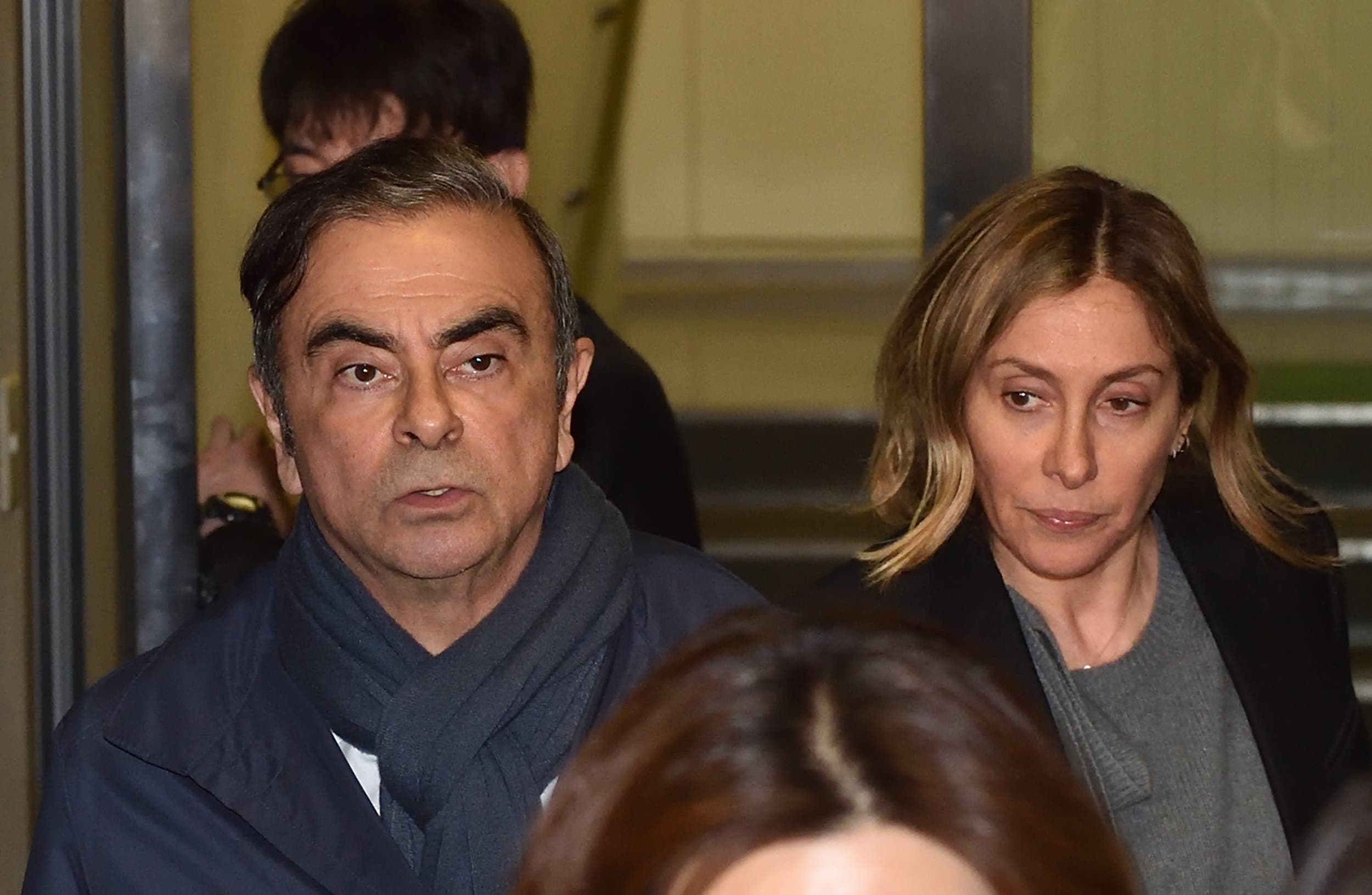 Former Nissan Chairman Carlos Ghosn (L) and his wife Carole (R) leave the office of his lawyer in Tokyo. (AFP)