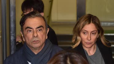 Former Nissan Chairman Carlos Ghosn (L) and his wife Carole (R) leave the office of his lawyer in Tokyo. (AFP)