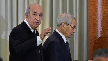 Algerian President-elect Abdelmadjid Tebboune (L) arrives with interim president Abdelkader Bensalah during the formal swearing-in ceremony in the capital Algiers on December 19, 2019. (AFP)