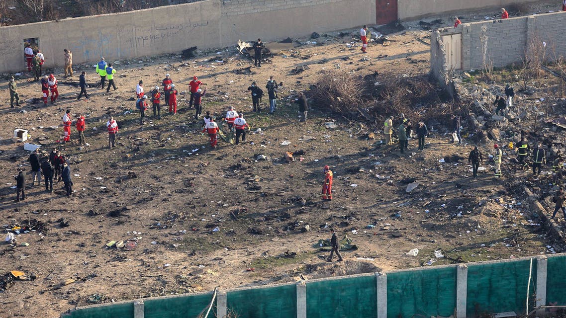 Rescue teams recover a body after a Ukrainian plane carrying 176 passengers crashed near Imam Khomeini airport in the Iranian capital Tehran early in the morning on January 8, 2020, killing everyone on board. The Boeing 737 had left Tehran's international airport bound for Kiev, semi-official news agency ISNA said, adding that 10 ambulances were sent to the crash site.