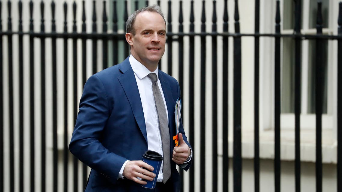 Britain's Foreign Secretary and First Secretary of State Dominic Raab carries a cup as he walks to the door of 10 Downing Street in central London on January 6, 2020.