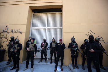 Members of Iraq's security forces stand guard outside one of the gates of the US embassy in Baghdad's Green Zone. (AFP)