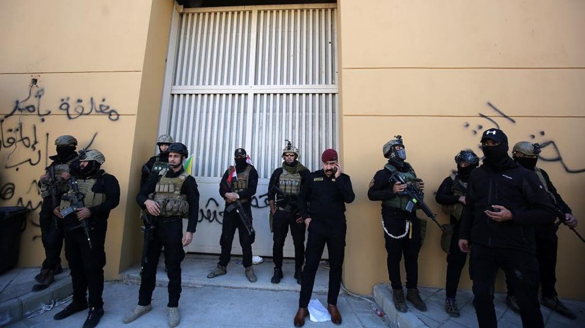 Members of Iraq's security forces stand guard outside one of the gates of the US embassy in Baghdad's Green Zone afp