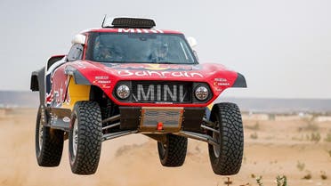 Mini's Spanish drivers Carlos Sainz of Spain and co-driver Lucas Cruz of Spain drives during a driving session on the eve of technical checkup in Jeddah. (AFP)