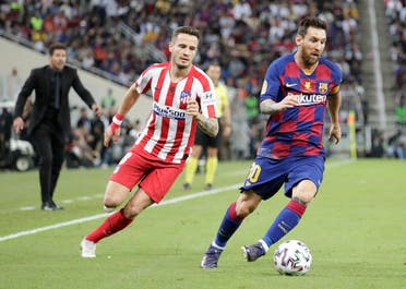 Barcelona's Lionel Messi controls the ball past Atletico Madrid's Saul during the Spanish Super Cup semifinal soccer match between Barcelona and Atletico Madrid at King Abdullah stadium in Jeddah, Saudi Arabia. (AP)
