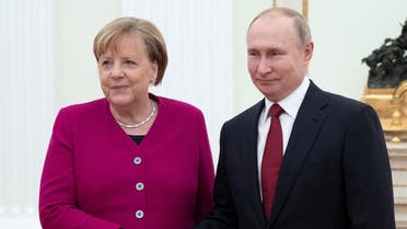 Russian President Vladimir Putin (R) welcomes and shakes hands with German Chancellor Angela Merkel (L) as they pose for a photo prior to their meeting at the Kremlin in Moscow, on January 11, 2020. (AFP)