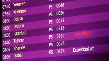 An electronic board displays information on flights including the one from Tehran marked as cancelled. (Reuters)