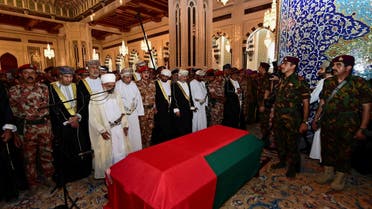 Oman's newly sworn-in Sultan Haitham bin Tariq al-Said prays with mourners next to the coffin of the late Sultan Qaboos in Muscat. (Reuters)