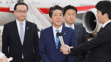 Japanese Prime Minister Shinzo Abe (C) speaks to the media before his departure at Tokyo's Haneda airport on January 11, 2020 for a five-day visit to the Middle East. (AFP)