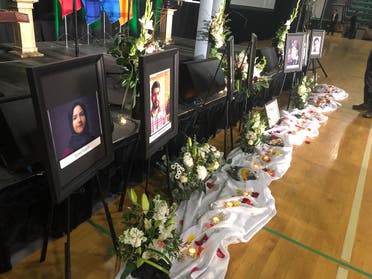 Photos of the victims are seen before the start of a memorial service for the Ukrainian Airlines flight PS752 victims, at the Saville Community Sports Centre in Edmonton, Canada, on January 12, 2020. (AFP)