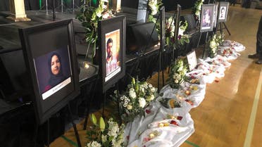 Photos of the victims are seen in front of the stage before the start of a memorial service for the Ukrainian Airlines flight PS752 who crashed in Iran at the Saville Community Sports Centre in Edmonton, Canada, on January 12, 2020. (AFP)