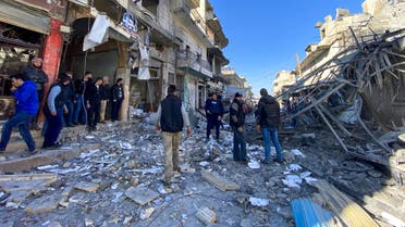 Syrians gather amidst the rubble following regime airstrikes on a market in the town of Binnish in Syria’s northwestern province of Idlib on January 11, 2020. (AFP)