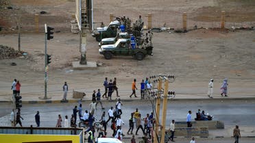 Members of Sudan's intelligence services (background) shoot bullets in the air at the headquarters of the Directorate of General Intelligence Service in Khartoum, on January 14, 2020. (AFP)