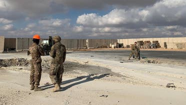 A picture taken on January 13, 2020 during a press tour organised by the US-led coalition fighting the remnants of the Islamic State group, shows US soldiers clearing rubble at Ain al-Asad military airbase in the western Iraqi province of Anbar. (AFP)