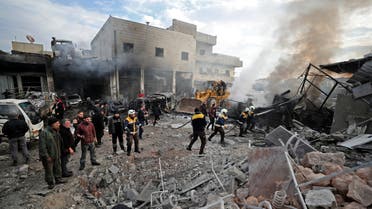 Members of the Syrian Civil Defence, also known as the White Helmets, extinguish a fire at the site of a regime air strike in Syria's last major opposition bastion of Idlib on January 15, 2020. At least 20 other civilians were wounded in the raids that hit a vegetable market and repair shops in Idlib, capital of the jihadist-held province of the same name, said the Syrian Observatory for Human Rights.