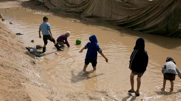 In this March 31, 2019, photo, children play in a mud puddle in the section for foreign families at Al-Hol camp in Hassakeh province, Syria. (AP)