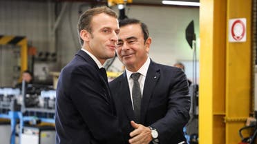 French President Emmanuel Macron (L) shakes hands with Chairman and CEO of Renault-Nissan-Mitsubishi Carlos Ghosn (R) during a visit of the Renault factory, in Maubeuge, northern France, on November 8, 2018. (AFP)
