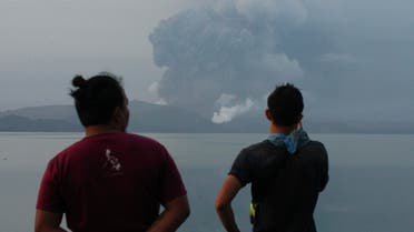 Residents watch Taal volcano spew ash from a look out in Talisay, Batangas province, southern Philippines on Monday, Jan. 13, 2020. (AP)