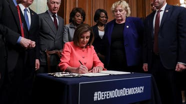 US House Speaker Pelosi holds engrossment ceremony to sign Trump impeachment articles at the US Capitol in Washington. (Reuters)