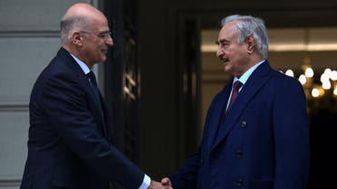 Greek Foreign Minister Nikos Dendias (L) welcomes Libyan strongman Khalifa Haftar before talks in Athens, on January 17, 2020, days ahead of a peace conference in Berlin which he and the head of Tripoli's UN-recognised government are expected to attend. The talks come as world powers step up efforts for a lasting ceasefire, nine months since an assault on Tripoli by Haftar's forces sparked fighting that has killed more than 280 civilians and 2,000 fighters, displacing tens of thousands.