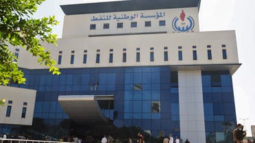 A picture taken on July 16, 2018, shows workers gathered at the building of the National Oil Corporation (NOC) of Libya, in the capital Tripoli on July 16, 2018. Four workers were kidnapped on July 14 from an oil field in southern Libya, with two of them later released, Libya's National Oil Corporation said.