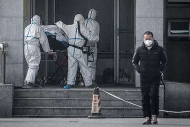 Medical staff members carry a patient into the Jinyintan hospital, where patients infected by a mysterious SARS-like virus are being treated, in Wuhan. (File photo: AFP)