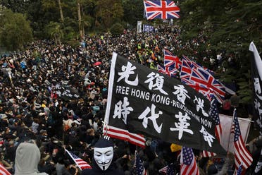 Participants wave British and US flags during a rally demanding electoral democracy in Hong Kong, on January 19, 2020. (AP)