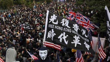 Participants wave British and US flags during a rally demanding electoral democracy and call for boycott of the Chinese Communist Party and all businesses seen to support it in Hong Kong, Sunday, Jan. 19, 2020.  (Photo: AP)