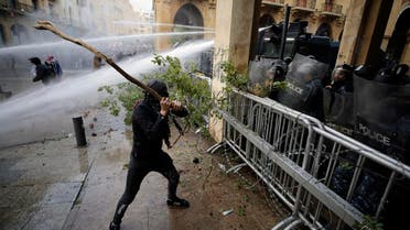 Anti-government demonstrators clash with riot police at a road leading to the parliament building in Beirut, Lebanon, Saturday, Jan. 18, 2020. (Photo: AP)