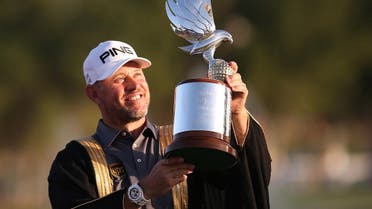 Lee Westwood of England poses with the trophy after winning the Abu Dhabi HSBC Golf Championship in the United Arab Emirates' capital. (AFP)