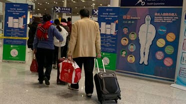 In this Jan. 13, 2020, photo, travelers pass by a health checkpoint before entering immigration at the international airport in Beijing. (AP)